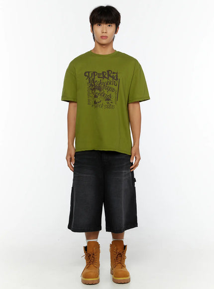 Men's Typography Graphic T-Shirt IL513 Green full-body front shot on male model standing straight showing SUPERRID graffiti graphic print with black shorts