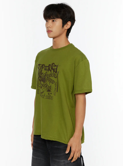 Men's Typography Graphic T-Shirt IL513 Green close-up side shot on male model showing graphic print detail crew neck and dropped shoulder oversized fit