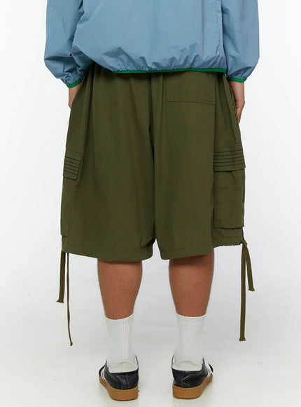Men's Utility Pocket Cargo Shorts IL515 olive green back view on model showing dual cargo pockets with ribbed detail and dangling drawstring cords