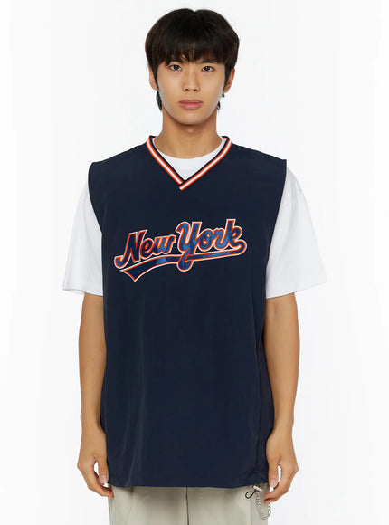 Men's Varsity Style Graphic Tank IL509 Dark blue front close-up shot on male model showing New York graphic layered over white tee with red orange stripe V-neck collar