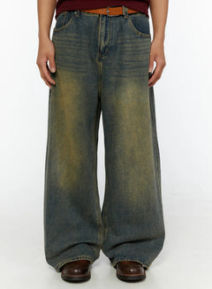 LEWKIN Men's Vintage Baggy Jeans IL510 Blue front close-up on model showing wide-leg silhouette, yellow-tinted wash, belt loops with tan leather belt, size S