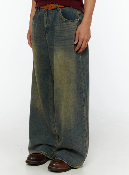 Men's Vintage Baggy Jeans IL510 Blue close-up side-angle shot on model highlighting voluminous wide-leg cut and yellow vintage wash texture with belt detail