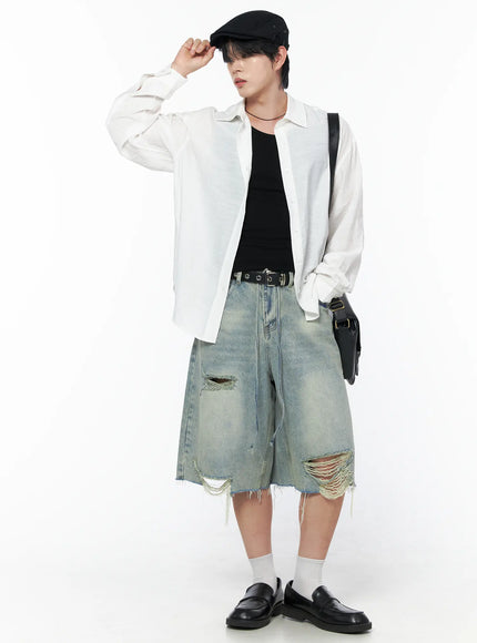 Men's Vintage Distressed Jorts IL502 Light blue full-body front view on model styled with white overshirt black tank flat cap and crossbody bag