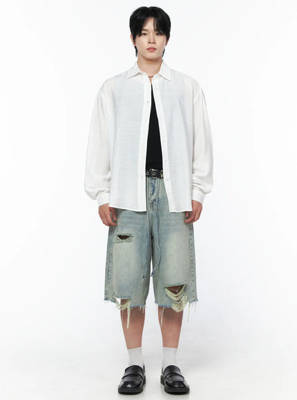 Men's Vintage Distressed Jorts IL502 Light blue full-body front view on model wearing white shirt black tank and belt with large ripped holes visible