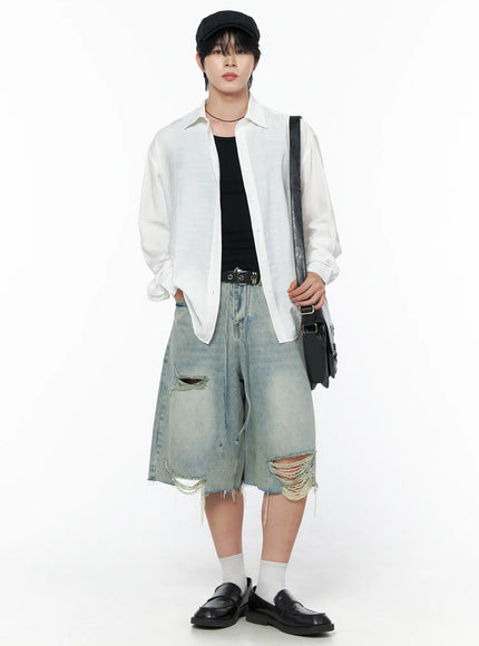 Men's Vintage Distressed Jorts IL502 Light blue full-body front view on model with flat cap white overshirt crossbody bag and distressed rips at hem