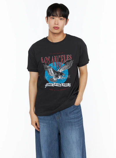 LEWKIN Men's Vintage Graphic Tee IL514 Black front view on male model wearing wide-leg blue jeans, Los Angeles eagle distressed graphic print