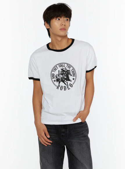 Men's Vintage Rodeo T-Shirt IL513 White front close-up on male model looking sideways showing black ringer collar and cowboy circular chest graphic
