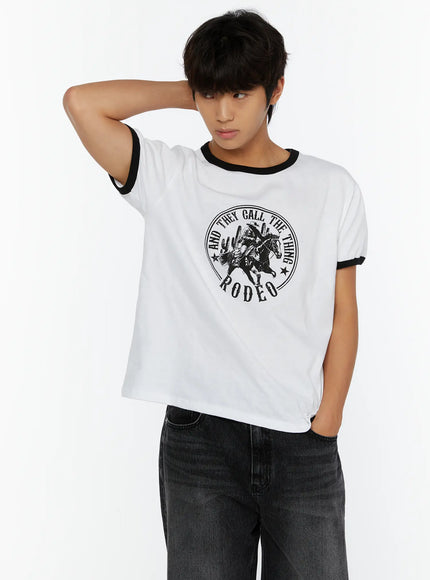 Men's Vintage Rodeo T-Shirt IL513 White cropped front shot on male model one hand on neck showcasing Rodeo cowboy circular graphic and black ringer trim