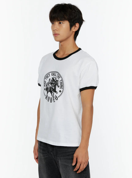 Men's Vintage Rodeo T-Shirt IL513 White side shot on male model showing Rodeo circular graphic black contrast ringer sleeve cuffs and cotton fabric