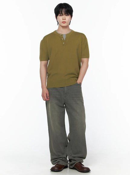 Men's Vintage Semi-Wide Jeans IL502 Gray three-quarter front view on model in olive knit top, hand on hip, highlighting wide-leg denim silhouette and faded wash detail