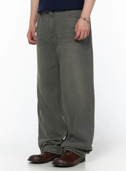 Men's Vintage Semi-Wide Jeans IL502 Gray side view on model wearing olive henley knit top, showing wide-leg silhouette and stacked denim hem with brown loafers