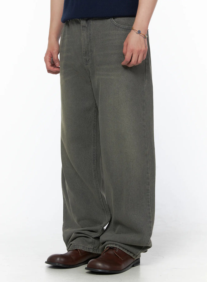 Men's Vintage Semi-Wide Jeans IL502 Gray side view on model wearing olive henley knit top, showing wide-leg silhouette and stacked denim hem with brown loafers