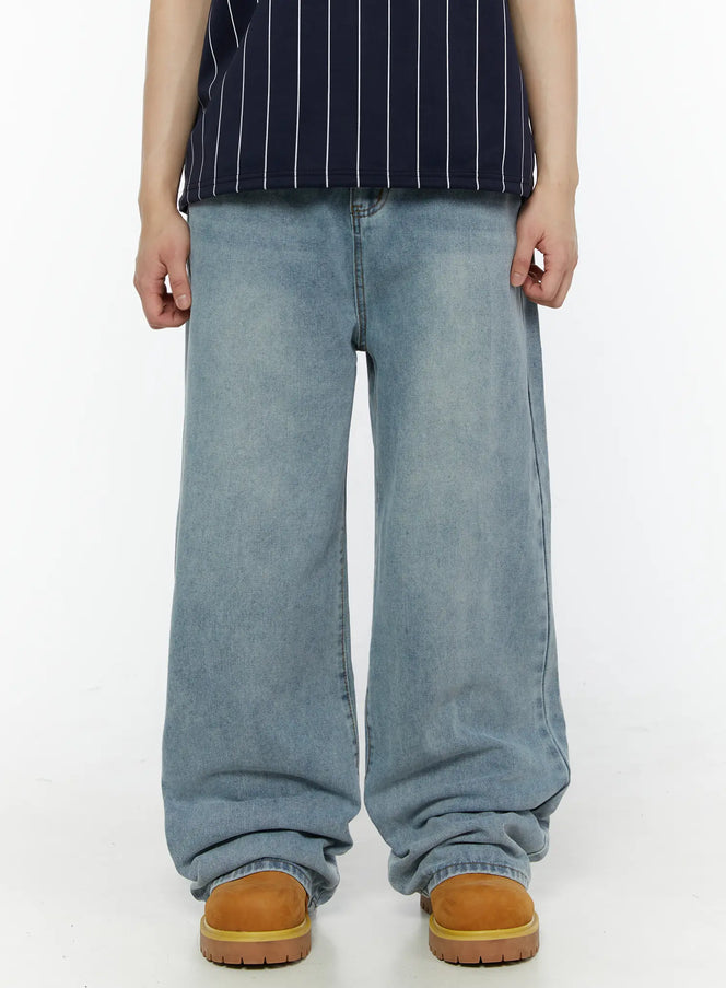 Men's Vintage Washed Wide Leg Jeans IL509 Light blue — front shot on male model, full-body, styled with navy NEWFORCE striped polo and tan lace-up boots