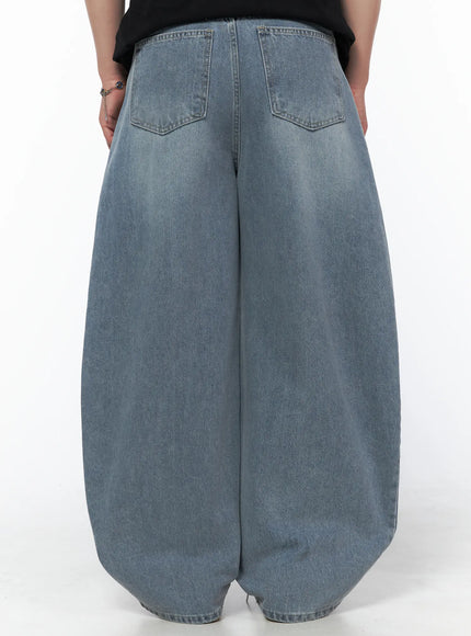 Men's Vintage Wide Leg Jeans IL502 Light blue full-body front shot on model in black velvet polo, hand on hip casual pose, brown leather loafers