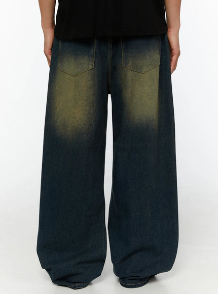 Men's Vintage Wide Leg Jeans IL510 indigo blue back close-up shot on male model showing dual patch pockets with bold yellow-green vintage fading and oversized leg width