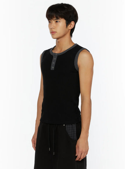 Men's Waffle Contrast Henley Tank IL507 Black side shot on model looking left, gray contrast trim visible on armhole, ribbed waffle texture