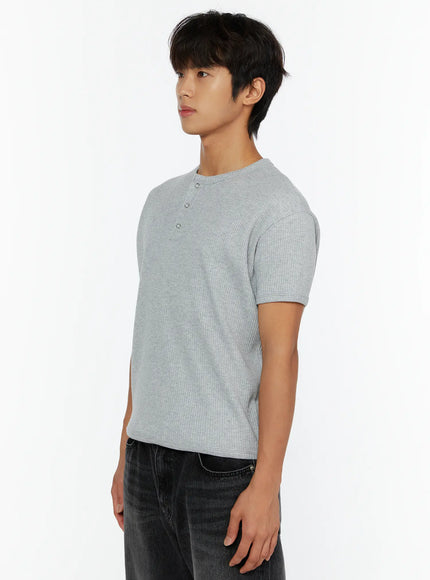 Men's Waffle Henley T-Shirt IL513 Gray three-quarter side view on male model arms relaxed showing three-button henley placket and ribbed waffle texture