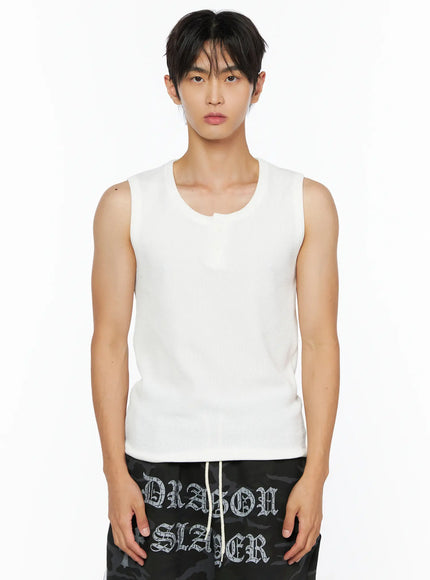 Men's Waffle Knit Henley Tank IL520 white close-up front shot on male model highlighting asymmetric U-neckline ribbed waffle knit texture paired with black camo Dragon Slayer shorts