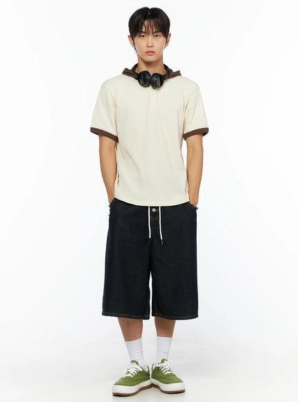 Men's Waffle Knit Hooded Henley Tee IL515 Light beige full-body front shot on male model with headphones around neck hands in pockets styled with dark denim wide shorts