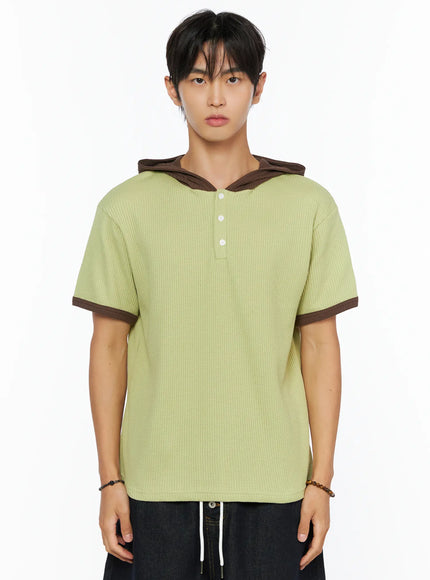 Men's Waffle Knit Hooded Henley Tee IL515 green close-up front shot on male model showing waffle knit fabric brown contrast hood brown sleeve cuffs and three henley buttons