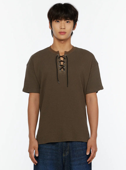 Men's Waffle Short Sleeve Tee IL515 Khaki front shot on male model showing waffle texture and lace-up neckline, arms relaxed at sides with jeans