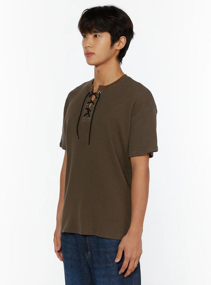 Men's Waffle Short Sleeve Tee IL515 Khaki side shot on male model looking left, showing waffle texture fabric and lace-up neckline detail