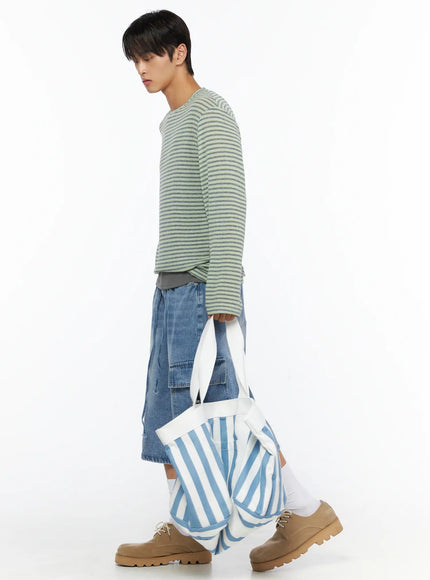 Men's Washed Cargo Jorts IL515 Light blue side shot on male model walking with striped knit top carrying large striped tote bag