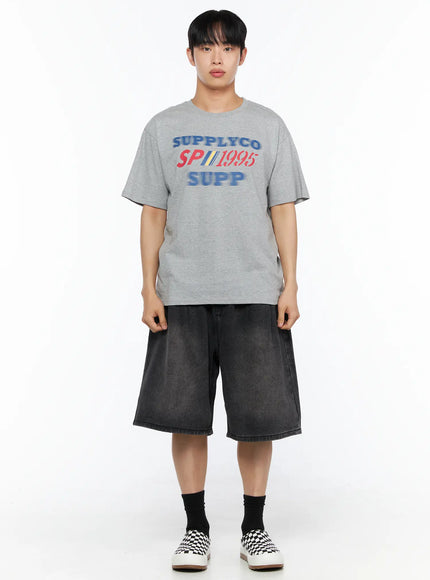 Men's Washed Pintuck Jorts IL514 Black front full-body shot on model wearing gray SUPPLYCO tee with crossbody bag and checkered sneakers