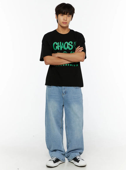 Men's Washed Wide Fit Jeans IL510 light blue full-body front shot on male model with arms crossed, styled with black graphic tee and sneakers
