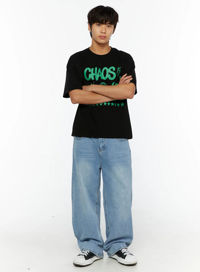 Men's Washed Wide Fit Jeans IL510 light blue full-body front shot on male model with arms crossed, styled with black graphic tee and sneakers