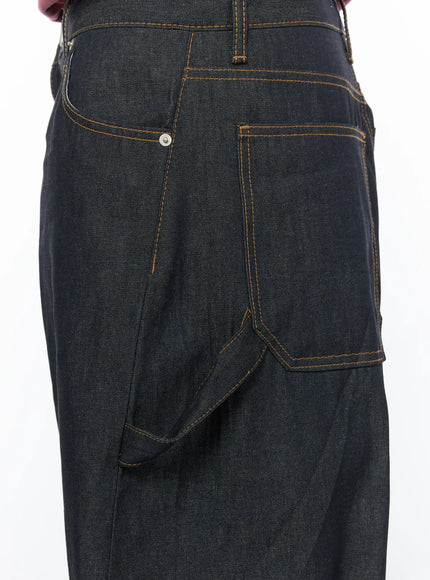 Men's Washed Wide Leg Jeans IL510 Black close-up detail of back hip area showing dual back pockets, rivet hardware and bold orange topstitching on raw denim
