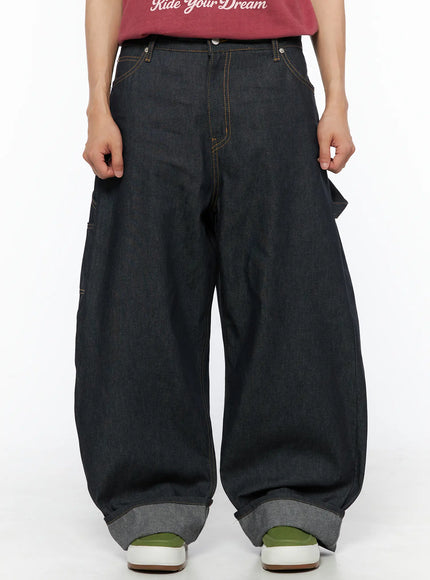 LEWKIN Men's Washed Wide Leg Jeans IL510 Black front crop shot on model wearing red tee, oversized balloon silhouette with orange contrast stitching and cuffed hem