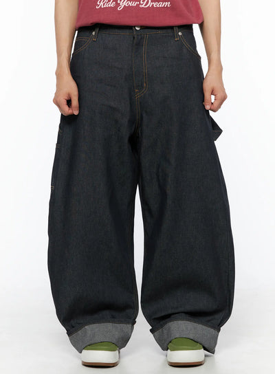 LEWKIN Men's Washed Wide Leg Jeans IL510 Black front crop shot on model wearing red tee, oversized balloon silhouette with orange contrast stitching and cuffed hem