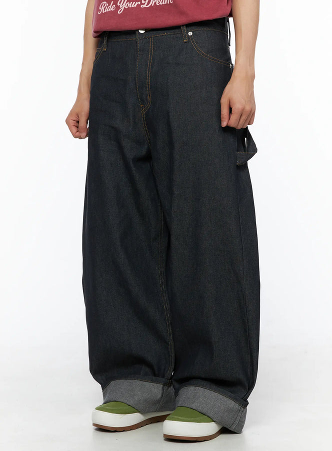 Men's Washed Wide Leg Jeans IL510 Black side-angle crop shot on model showing carpenter pocket detail, orange topstitching and wide-leg denim silhouette