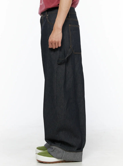 Men's Washed Wide Leg Jeans IL510 Black side shot on model showing right-side thigh carpenter pocket with orange contrast stitching and wide barrel leg