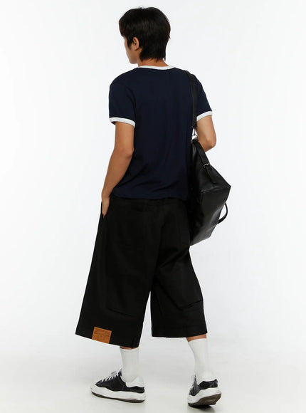 Men's WIde Cargo Bermuda Shorts IL513 Black full back view on model with navy College League Football tee and black bag, wide-leg bermuda length