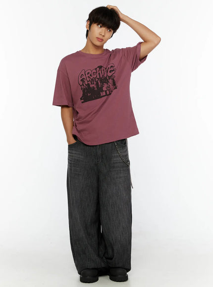 Men's Wide Leg Balloon Jeans IL515 Black three-quarter full-body on male model with one hand in hair, styled with pink Archive graphic tee and chain detail on waist