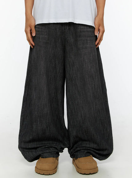 LEWKIN Men's Wide Leg Balloon Jeans IL515 Black front close-up on model showing extreme wide-leg silhouette, denim texture, and pooling hem with tan loafers