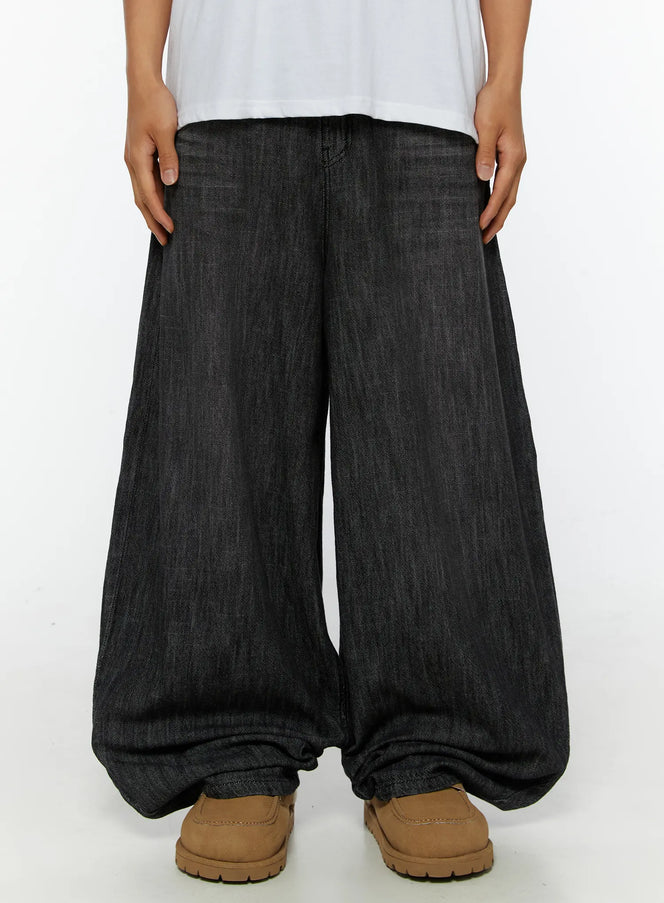 LEWKIN Men's Wide Leg Balloon Jeans IL515 Black front close-up on model showing extreme wide-leg silhouette, denim texture, and pooling hem with tan loafers