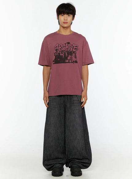 Men's Wide Leg Balloon Jeans IL515 Black front full-body on male model standing facing camera, styled with pink Archive graphic tee and chain accessory, black shoes