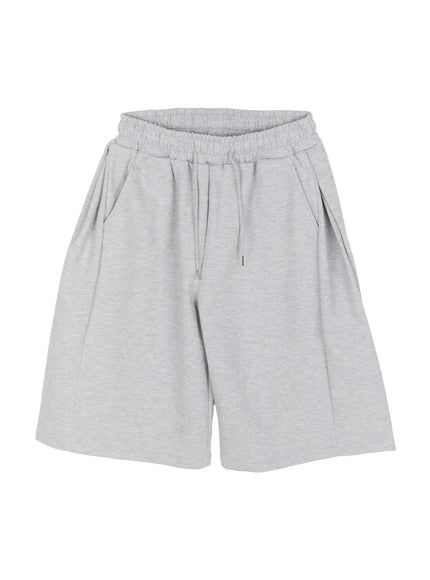 Men's Wide Leg Bermuda Sweat Shorts (Gray) IU529 Gray flat-lay angled view highlighting ruched elastic waistband drawstring and wide-leg cut in heathered gray cotton fleece fabric