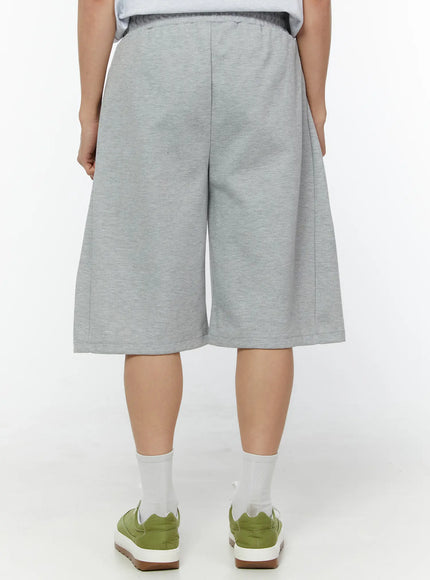 Men's Wide Leg Bermuda Sweat Shorts (Gray) IU529 Gray flat-lay front showing elastic drawstring waistband side pockets pintuck seams and wide-leg silhouette in heathered cotton fleece