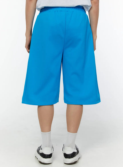 Men's Wide Leg Bermuda Sweat Shorts (Light blue) IU529 Light blue back view on model showing elastic waistband center back seam and wide-leg knee-length hem