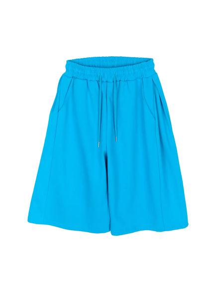 Men's Wide Leg Bermuda Sweat Shorts (Light blue) IU529 Light blue flat-lay front view showing full silhouette elastic ruched waistband drawstring side pockets and wide-leg shape