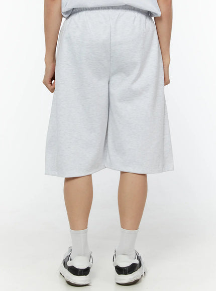 Men's Wide Leg Bermuda Sweat Shorts (Light Gray) IU529 Light Gray back view on model showing clean elastic waistband, wide-leg fit and heathered sweat fabric