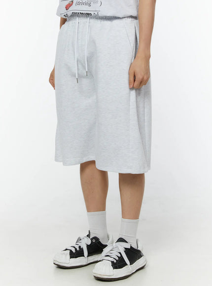 Men's Wide Leg Bermuda Sweat Shorts (Light Gray) IU529 Light Gray angled side view on model showing drawstring waist, wide-leg cut and heathered cotton texture