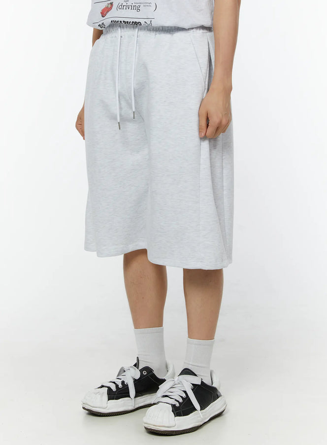 Men's Wide Leg Bermuda Sweat Shorts (Light Gray) IU529 Light Gray angled side view on model showing drawstring waist, wide-leg cut and heathered cotton texture