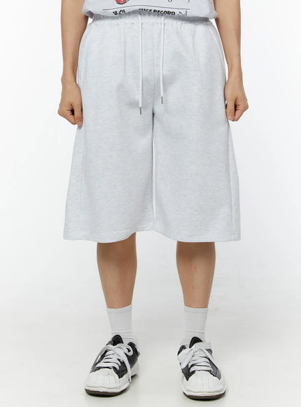 LEWKIN Men's Wide Leg Bermuda Sweat Shorts (Light Gray) IU529 Light Gray front view on model size M/L with elastic drawstring waist and wide-leg silhouette
