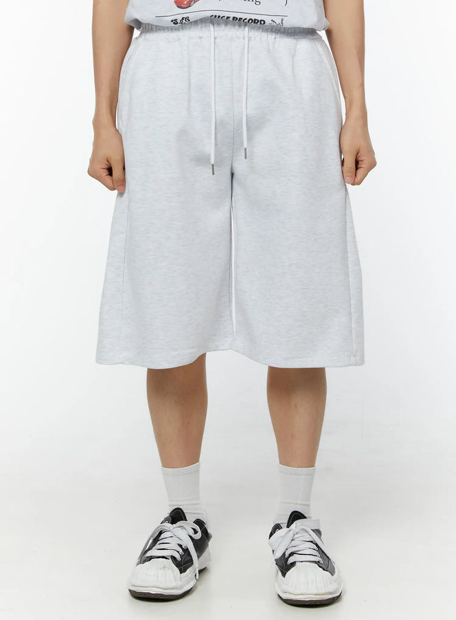 LEWKIN Men's Wide Leg Bermuda Sweat Shorts (Light Gray) IU529 Light Gray front view on model size M/L with elastic drawstring waist and wide-leg silhouette