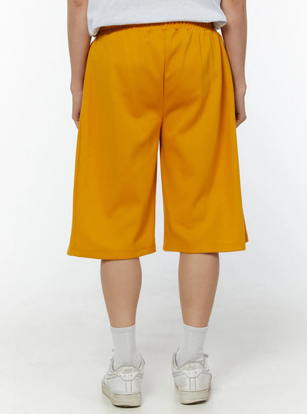 Men's Wide Leg Bermuda Sweat Shorts (Yellow) IU529 yellow back view on model showing elastic waistband, wide-leg silhouette and clean back panel styling
